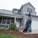 Matt and Heather Lutz;s home was destroyed by the tornado on March 15, 2012. Here, Matt and Heather, as well as their dog Brady, stand outside their nearly-completed home on Oct. 6, 2012. Courtney Sacco I AnnArbor.com 